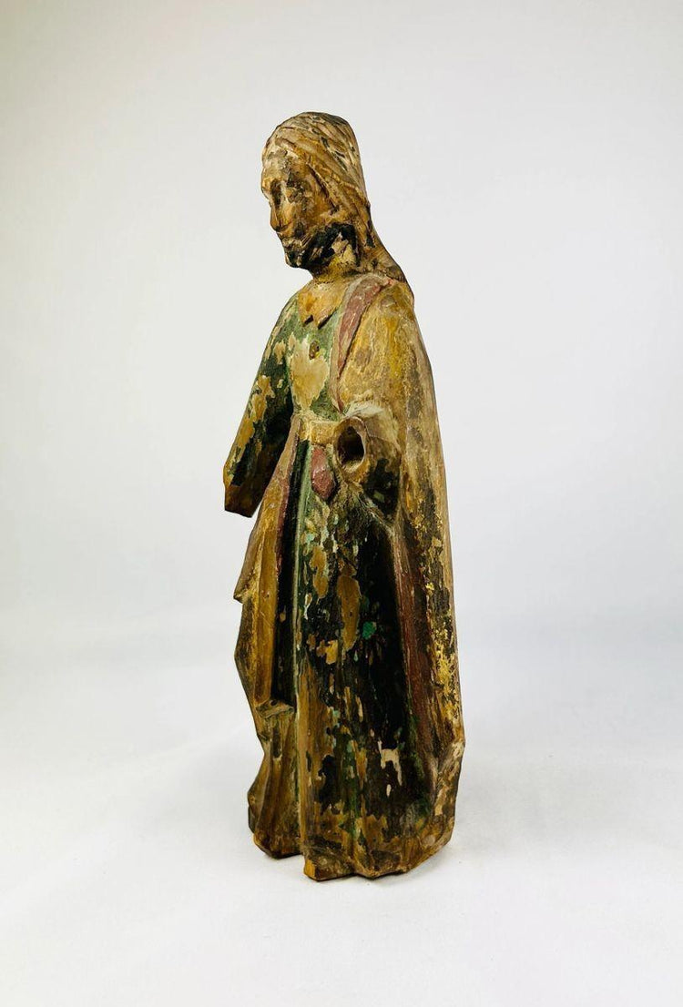 17th–18th century religious folk art statue in carved wood, displaying cracks, aged patina, and faded paint