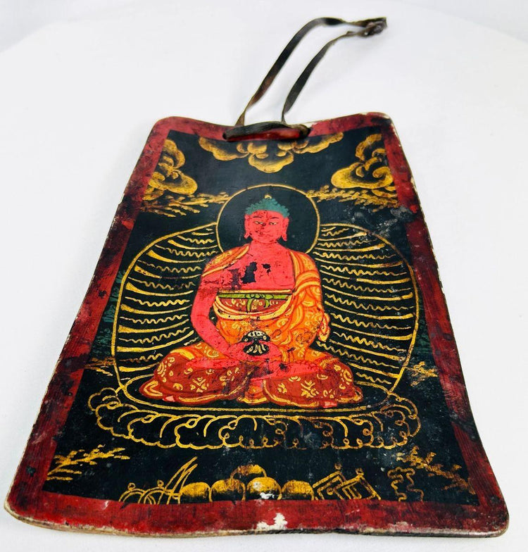 Front view of a 19th-century Tibetan devotional bone amulet with lotus throne imagery