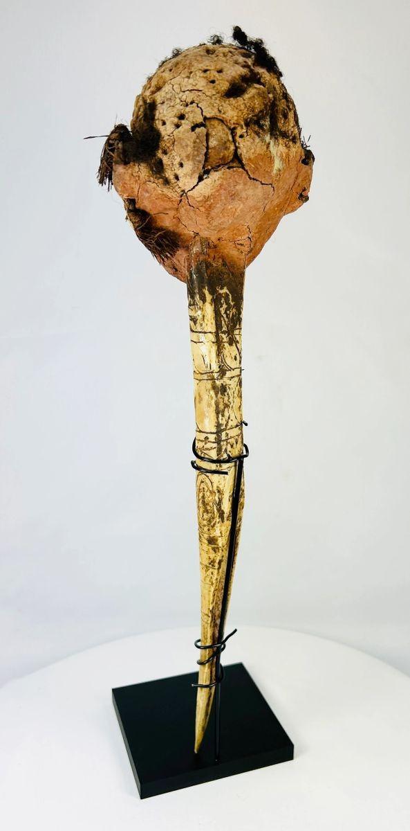 Rear view of Papua New Guinea ancestral head carving on ceremonial dagger, displaying aged patina and traditional hair binding.