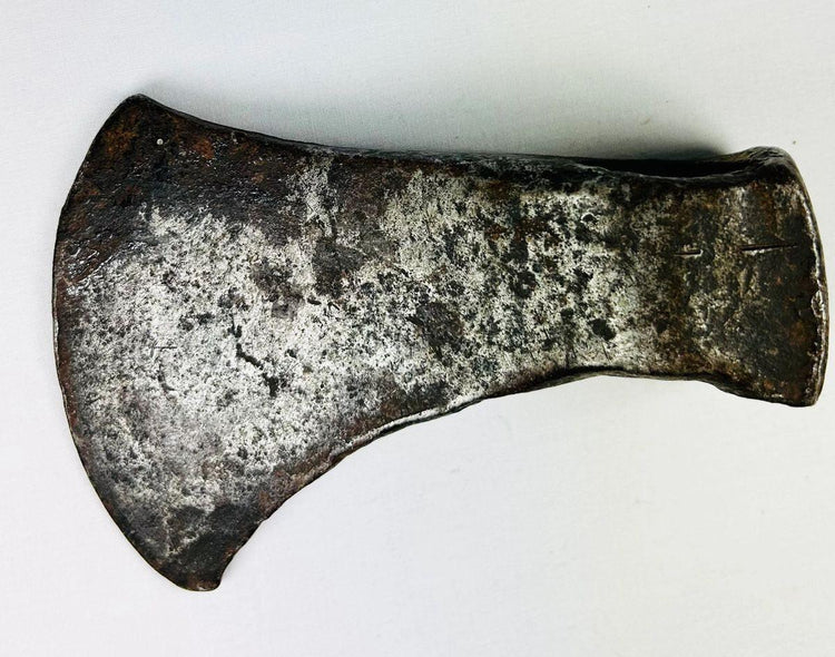 19th-century frontier-era hand-forged iron axe head showing tapered cutting edge and aged patina