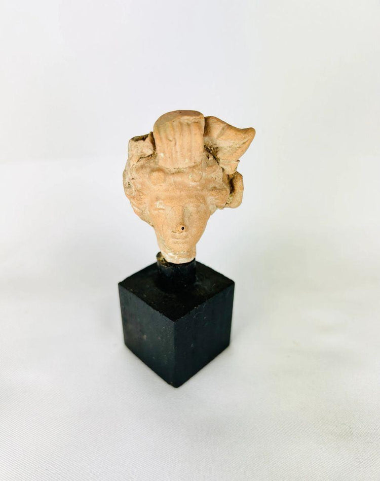 Ancient terracotta head figurine fragment from the Greco-Roman Mediterranean, 1st–2nd century CE.