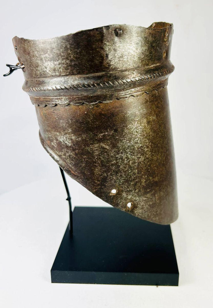 Historical 16th-century armor component, forged steel arm defense with ornamental incisions and weathered battlefield wear.