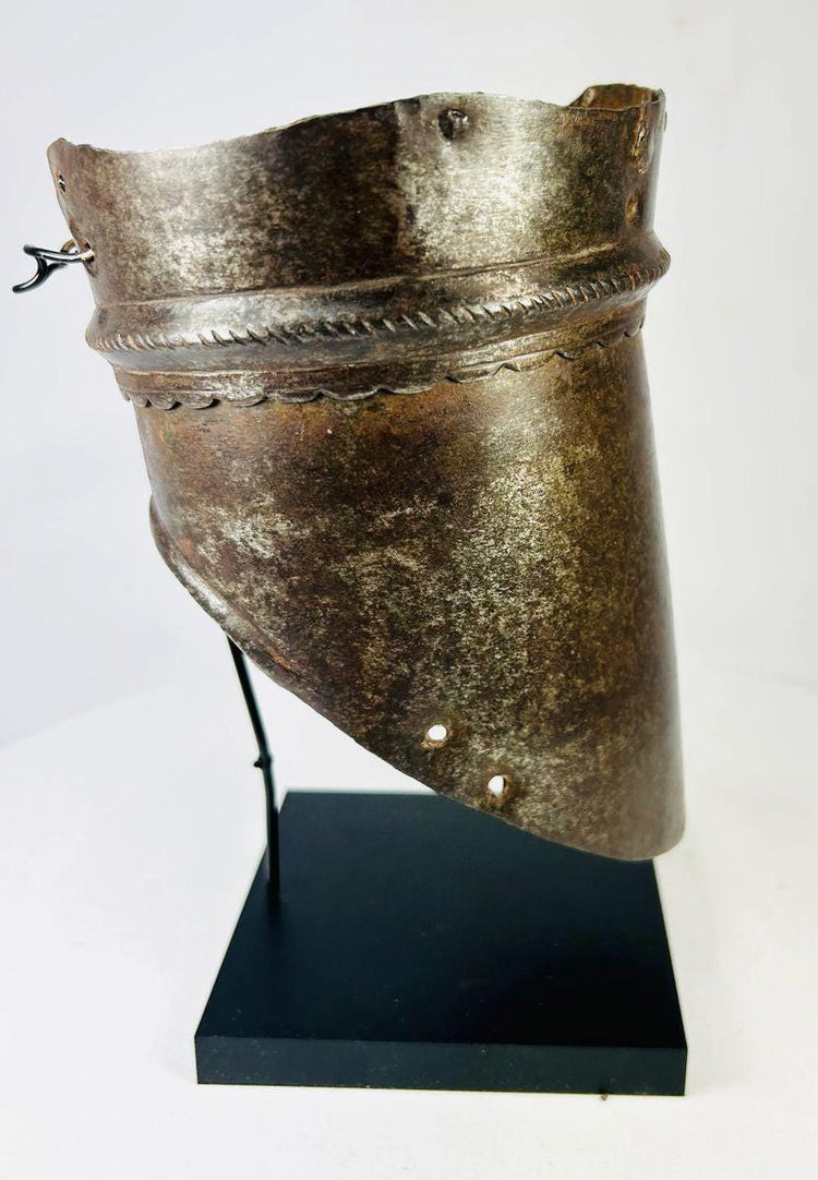 Historical 16th-century armor component, forged steel arm defense with ornamental incisions and weathered battlefield wear.