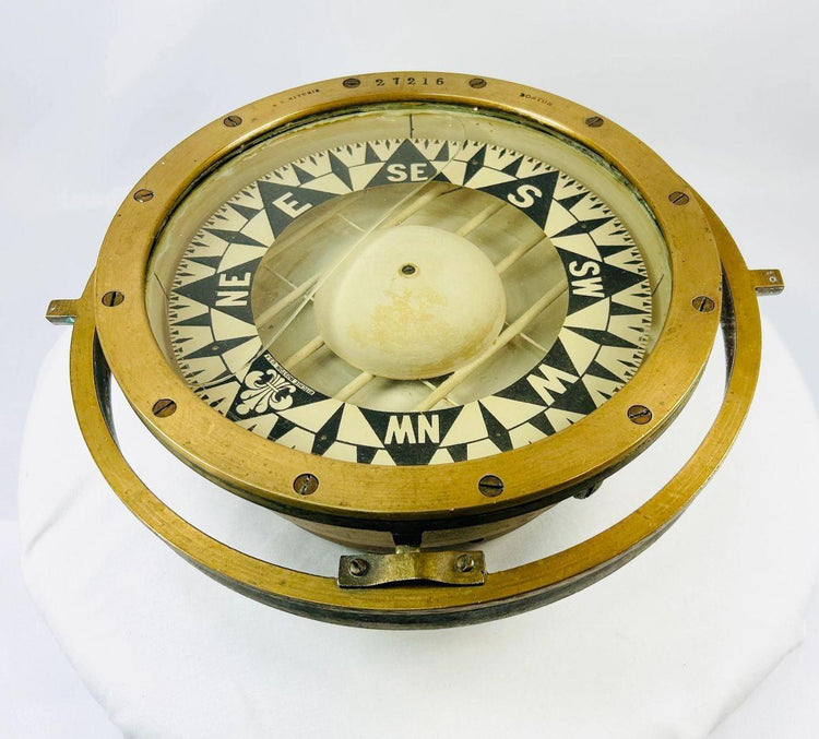 Early 20th-century brass and wood marine compass collectible with aged patina.
