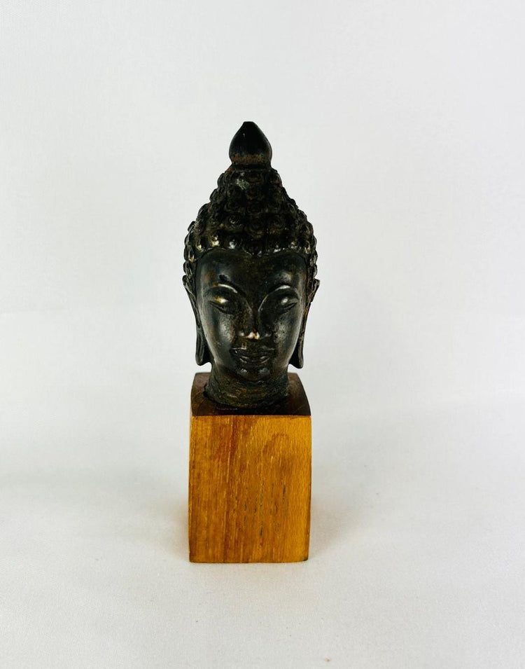 Authentic Southeast Asian bronze Buddha head 18th–19th century CE with serene expression and aged patina