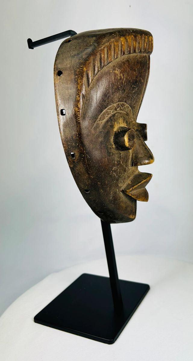 Ceremonial Baule mask from Ivory Coast with refined facial symmetry and scarification marks