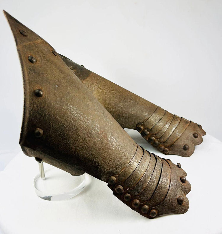 Close-up of articulation and engravings on Gothic-style steel gauntlets.