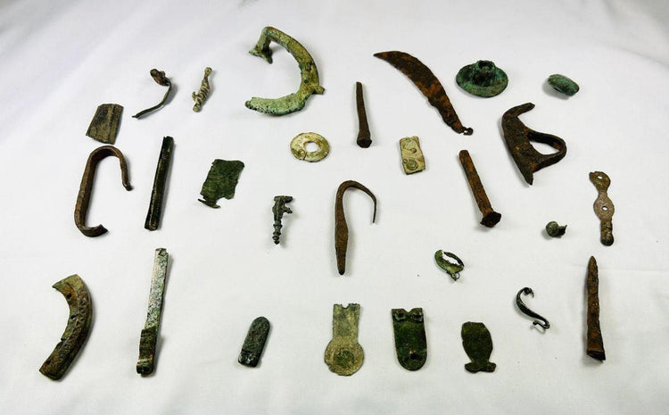 Historic Roman bronze fragments with natural aging and patina, representing daily life and spiritual practices