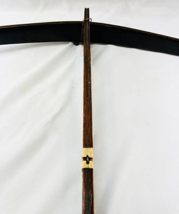 Historic Nu ethnic minority crossbow frame with aged wood texture and bone release piece.