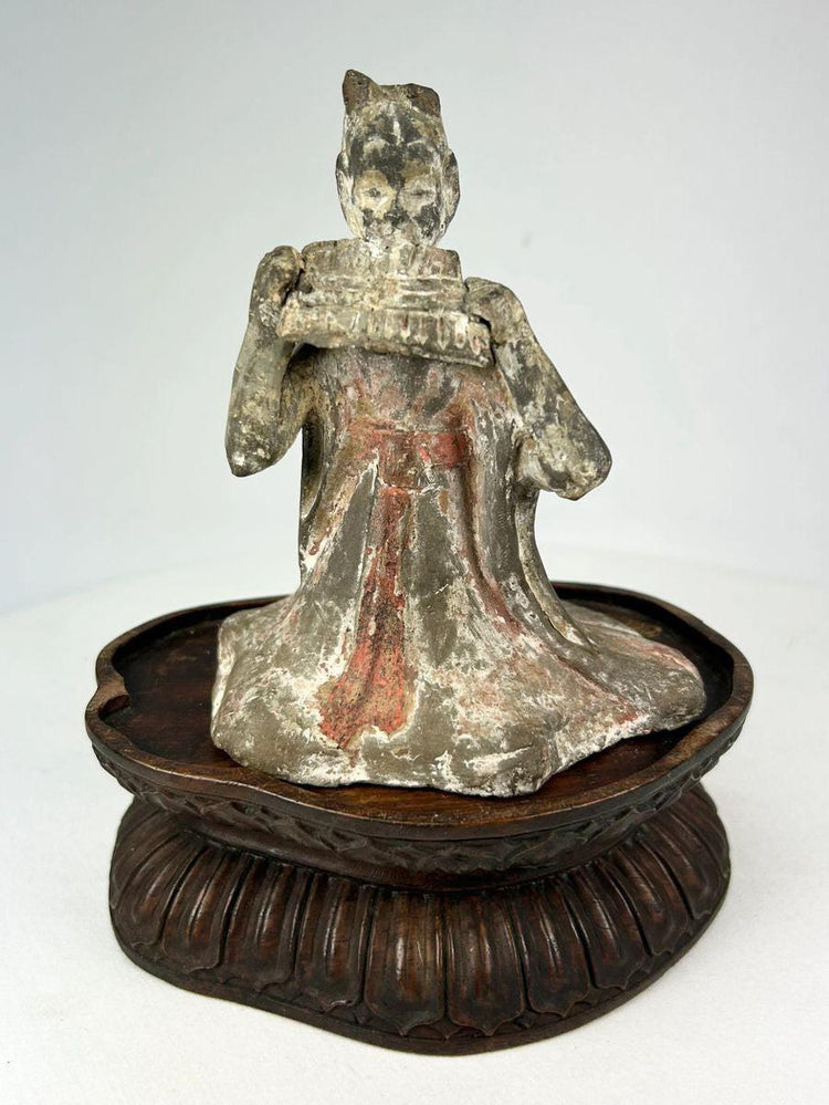 Tang Dynasty terracotta figure of female musician with red and white pigment traces