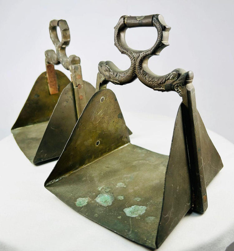 Brass horse stirrups with triangular footrest and guardian-themed design