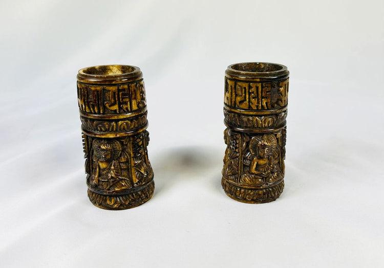 Pair of 19th-century Tibetan thigh bone prayer wheel cylinders with carved Buddhist deities and sacred inscriptions, authentic ritual artifacts from Relic and Rarity.