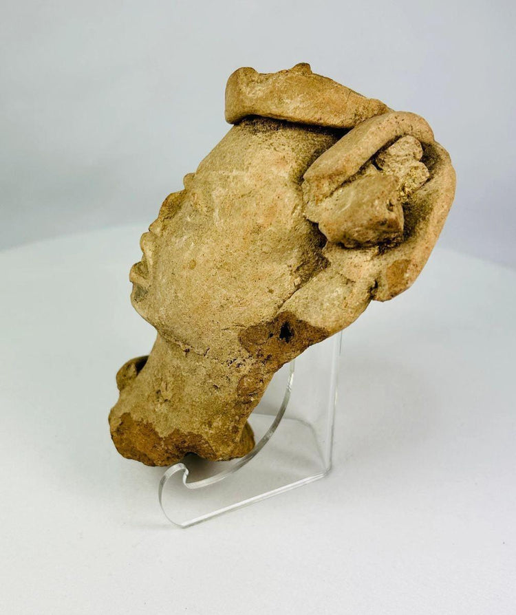 Historic Mesoamerican terracotta head artifact photographed for detailed examination