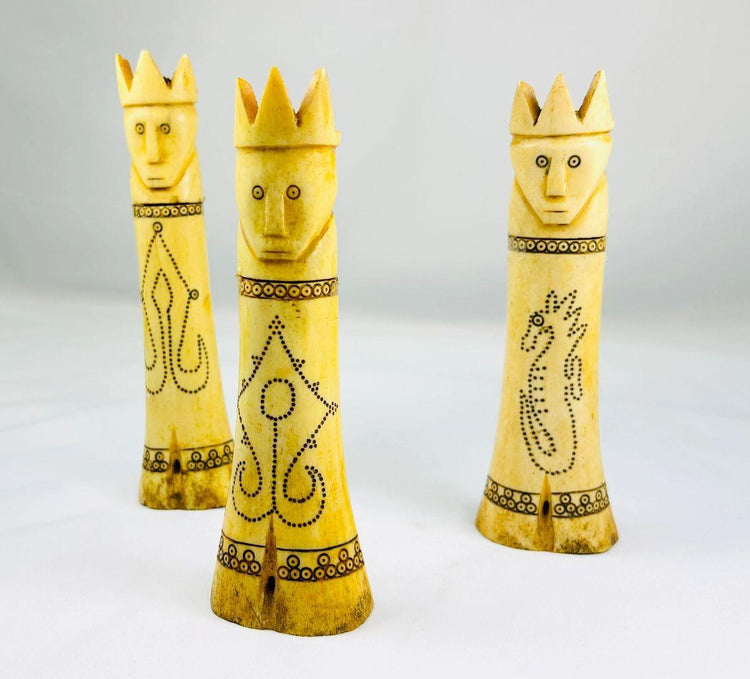 Set of three early 20th-century Indonesian carved buffalo bone lime containers