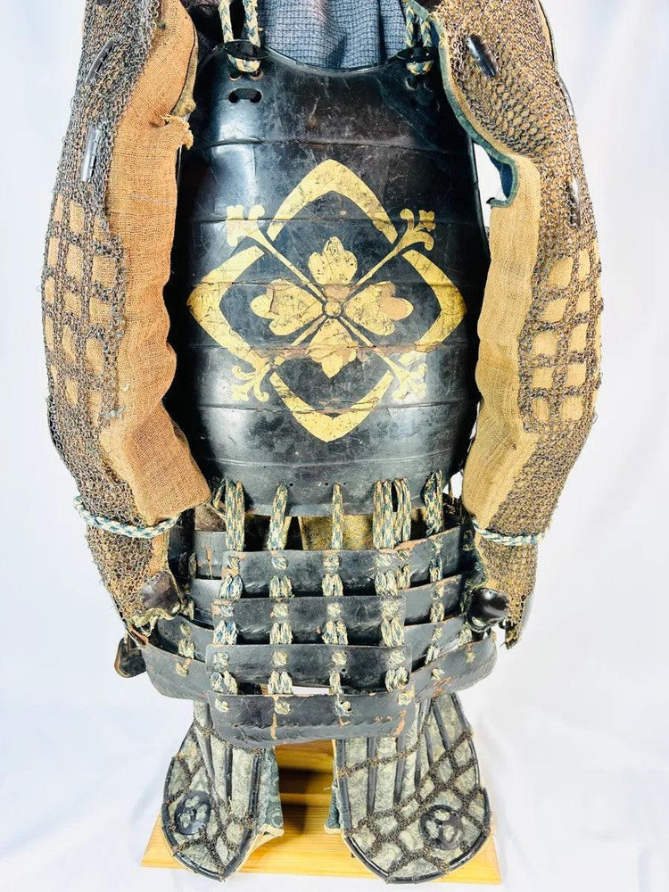 Muromachi samurai armor set with menpo, kabuto, cuirass, and silk lacing on wooden display stand.