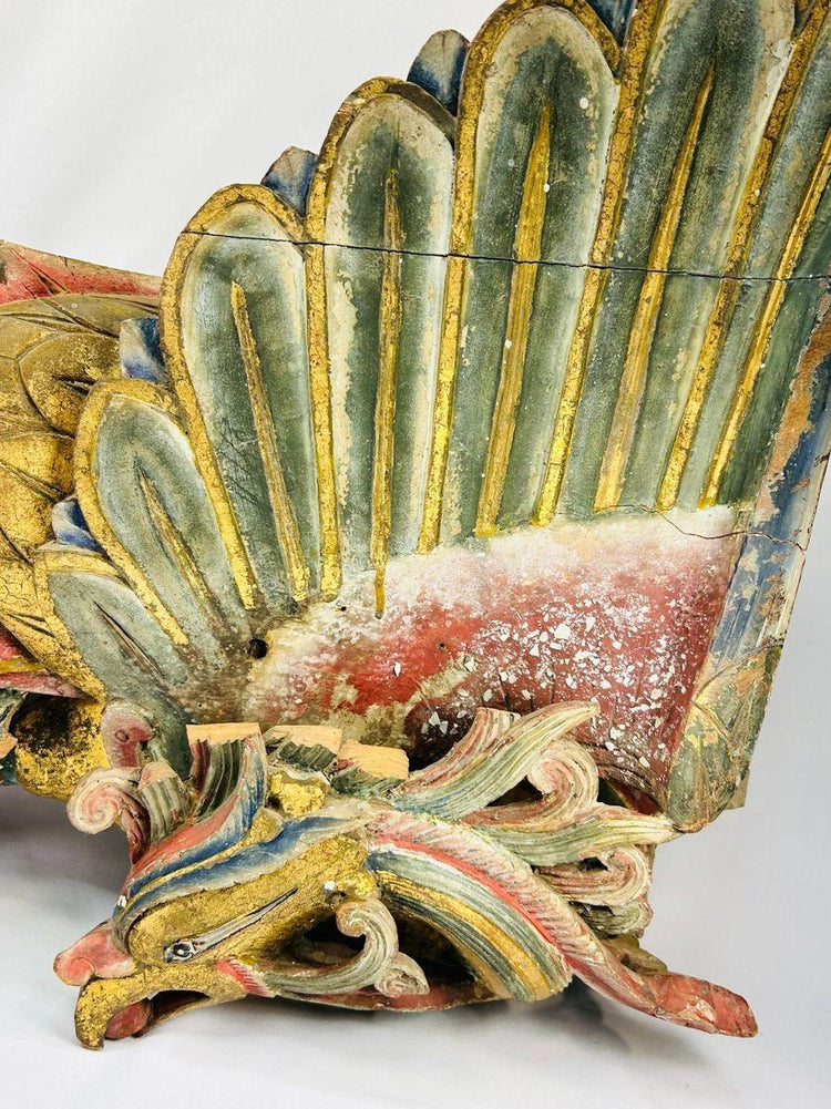 Close-up of gilded phoenix wing from Qing Dynasty camphor wood relief, showing layered carving, polychrome pigments, and ornate scrollwork base – Relic and Rarity.