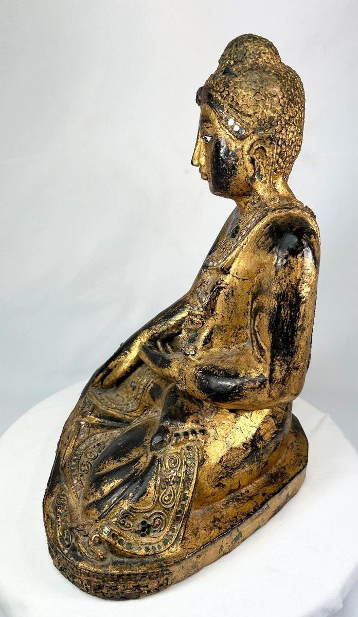 Thai Buddha in Bhumisparsha Mudra – hand-carved gilt wooden figure with glass inlays, 19th–early 20th century temple art from Thailand, symbolizing enlightenment and spiritual awakening.
