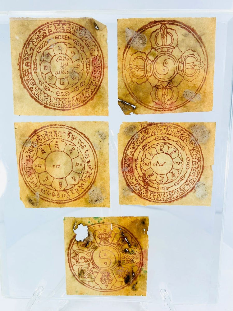 Antique Tibetan Buddhist yantra set featuring sacred diagrams and mantras in red ink