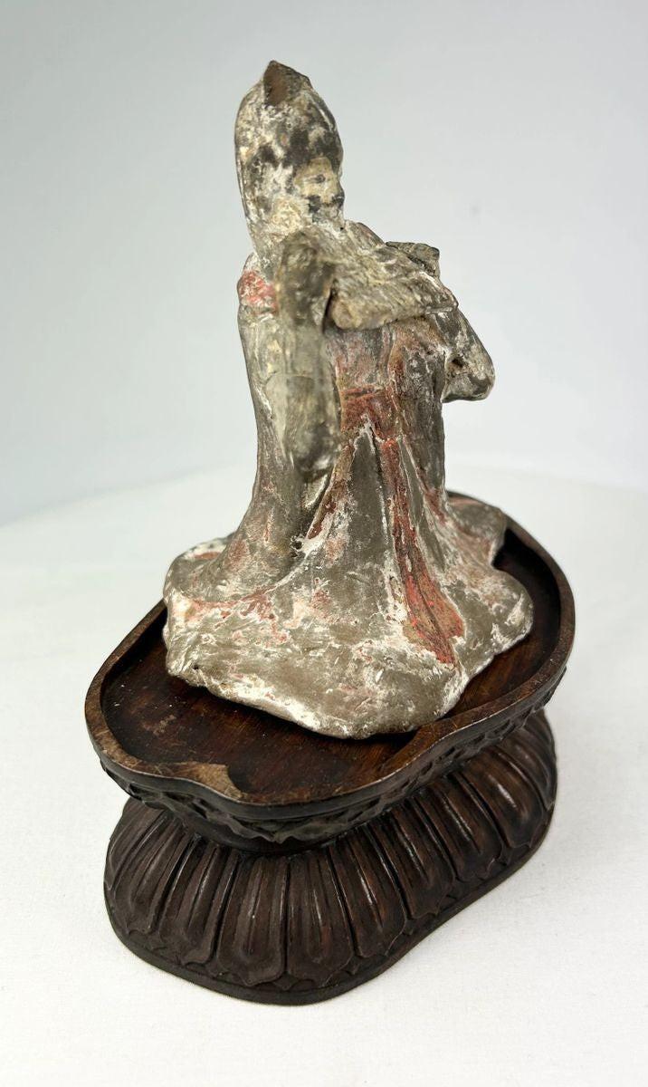 Tang Dynasty terracotta court musician with traces of red and white pigments