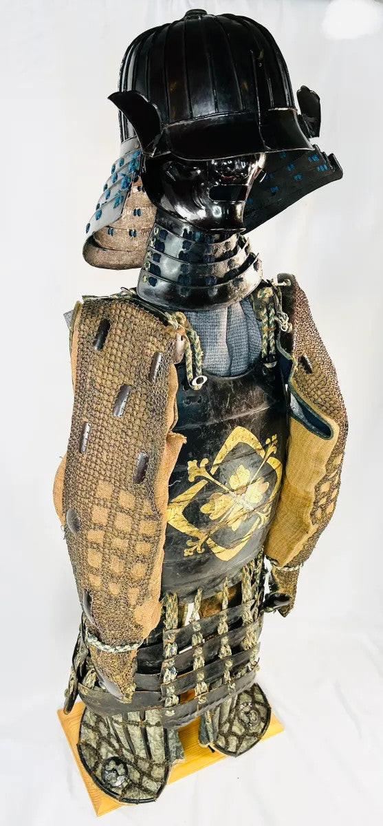 Right side profile of authentic Muromachi Samurai armor set with black lacquer kabuto, menpo mask, and Edo-period silk cords.