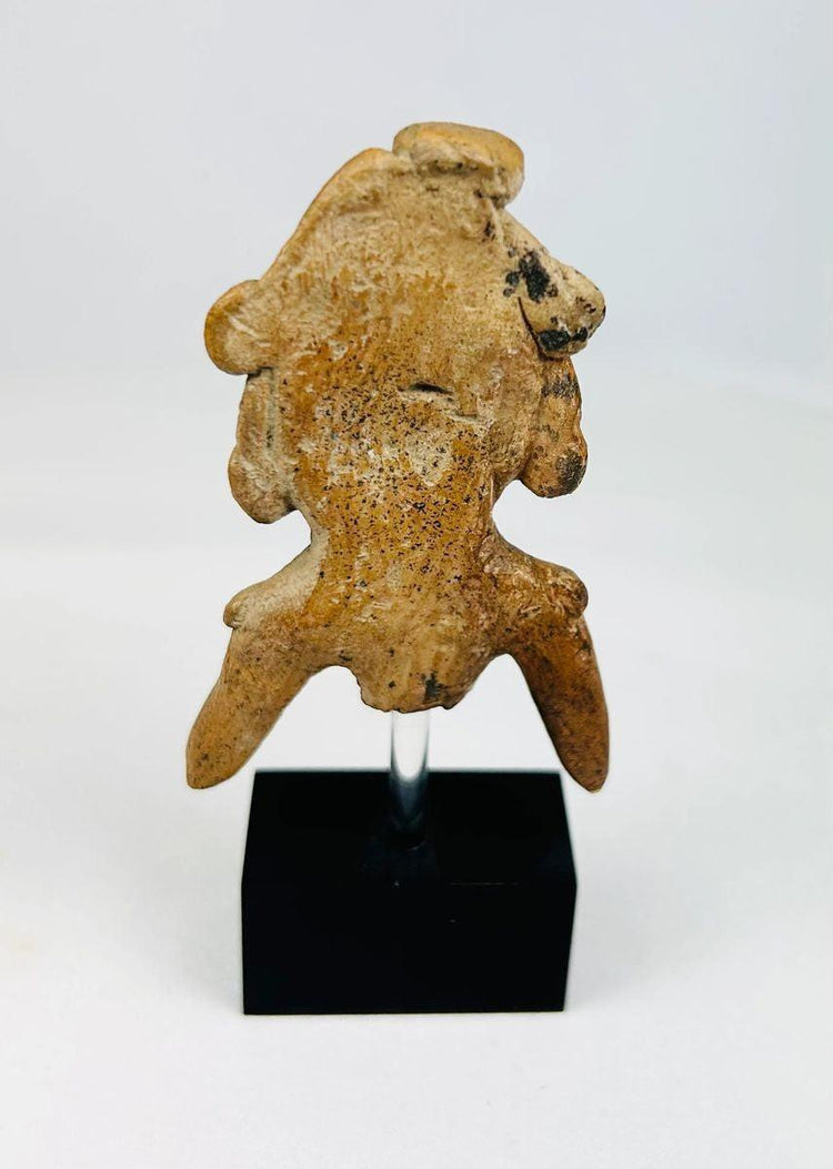 Pre-Columbian terracotta artifact on black museum display stand