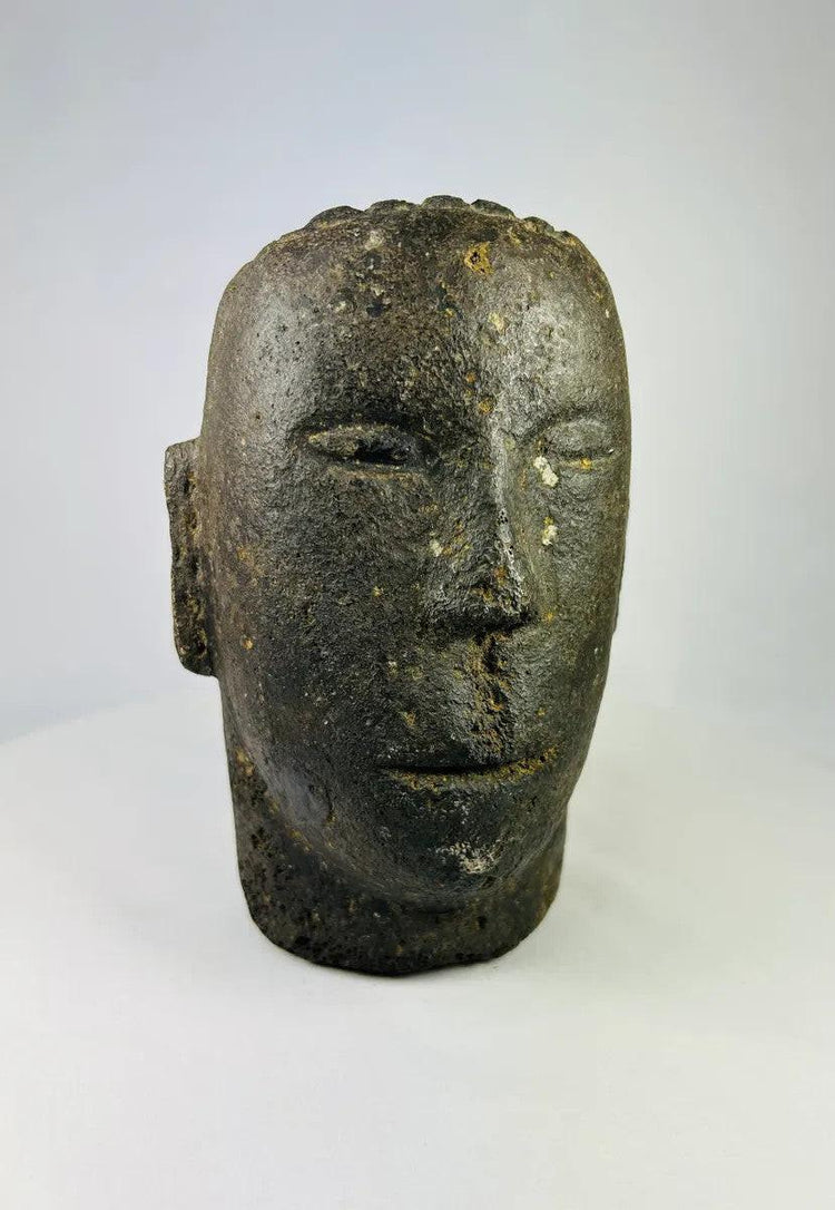 Close-up of carved facial details on a Polynesian volcanic stone ancestor effigy.