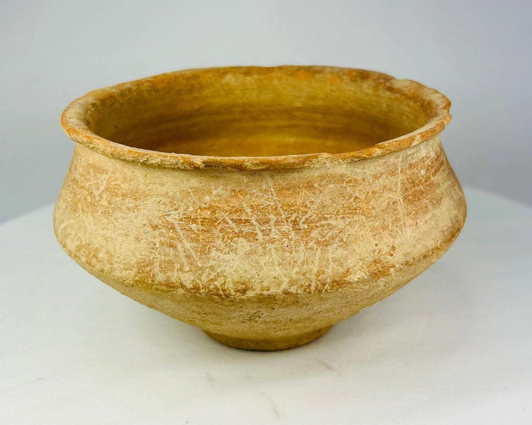 Hand-thrown Bronze Age ceramic bowl showing natural patina and age wear