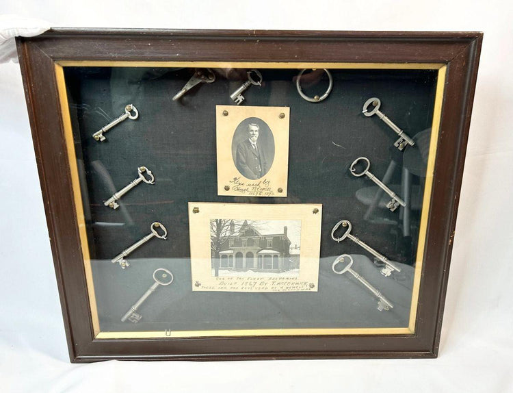Antique locksmith display with iron keys and period portrait