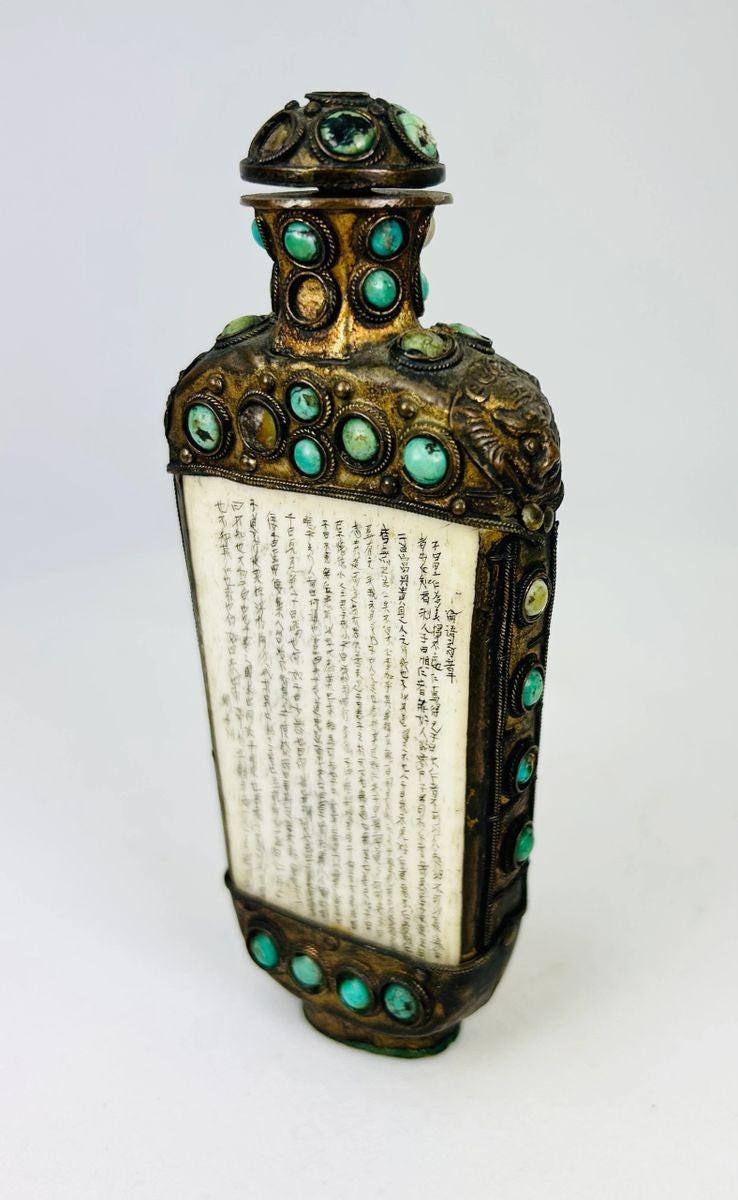 Late 19th-century Qing Dynasty ritual flask featuring turquoise inlay, carved panels, and ornate chased bronze detailing
