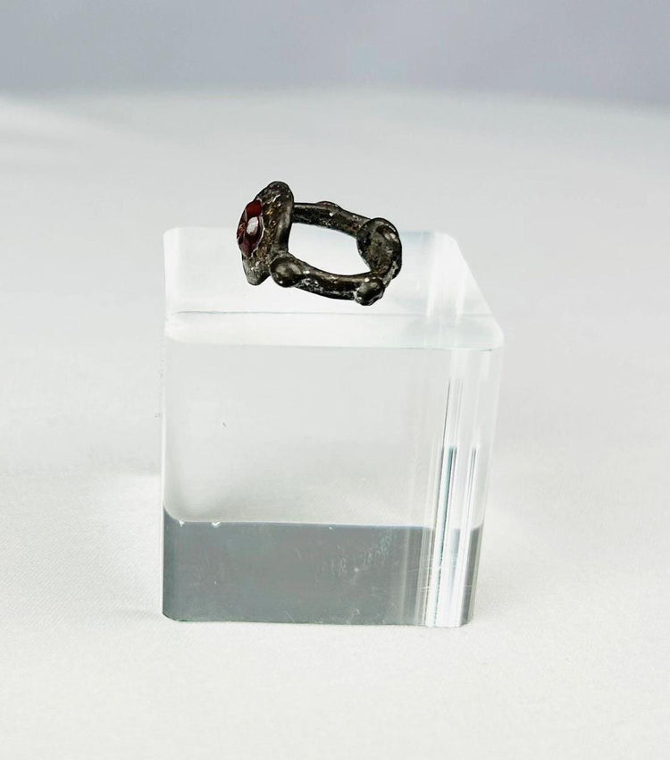 Antique silver ring featuring symbolic engraved garnet gemstone
