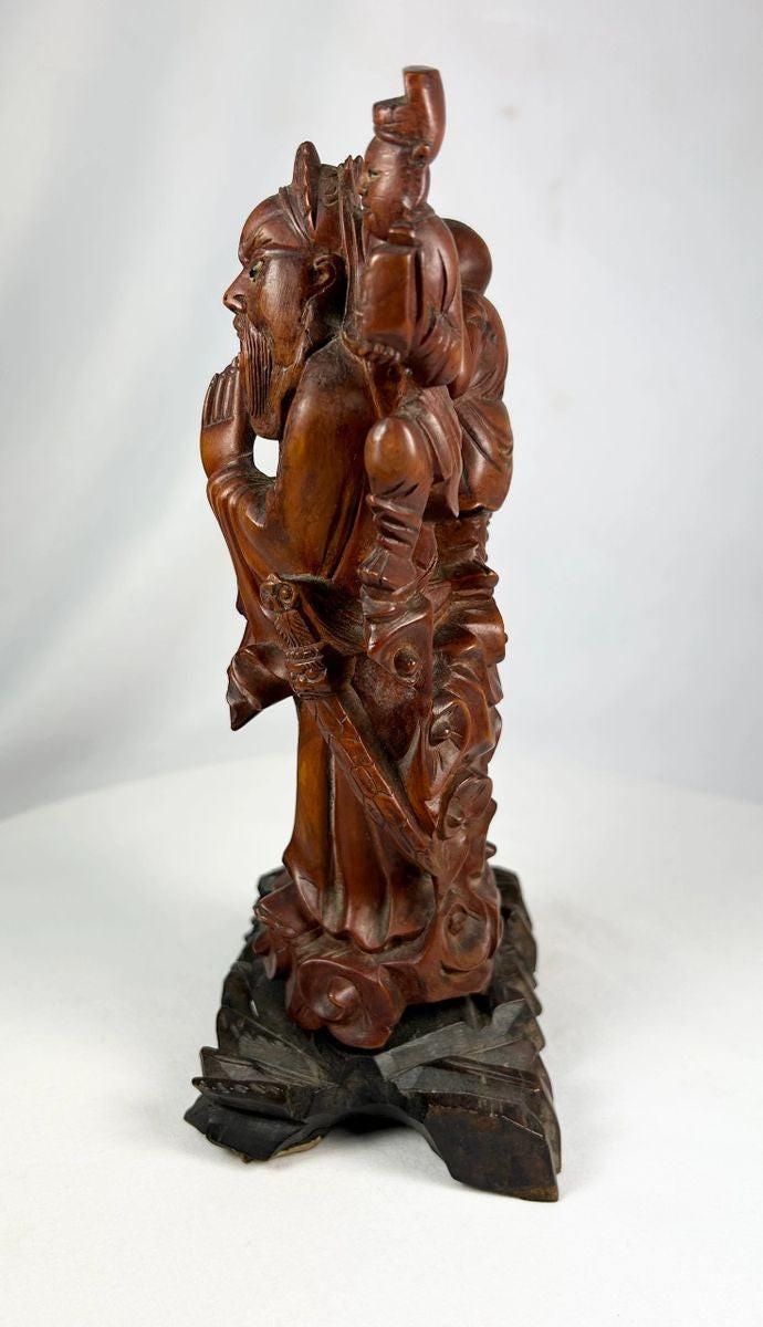 Antique Chinese hardwood sculpture of immortal figure with carved base