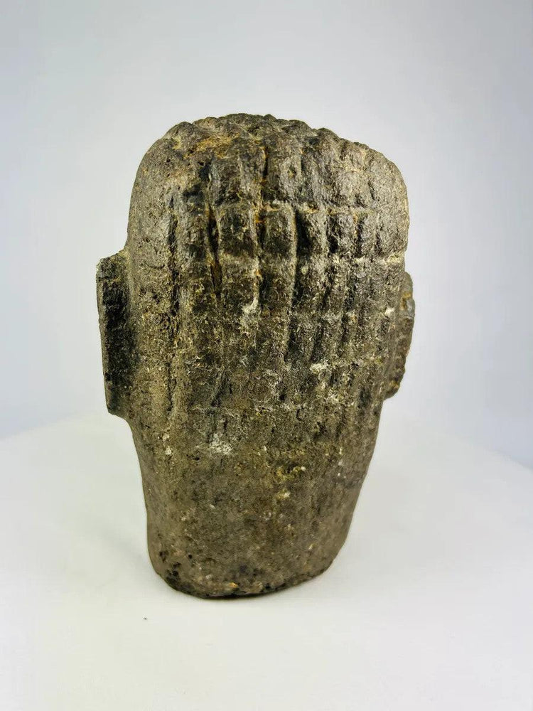 Polynesian ancestor effigy head carved in basalt, displayed against a neutral background.