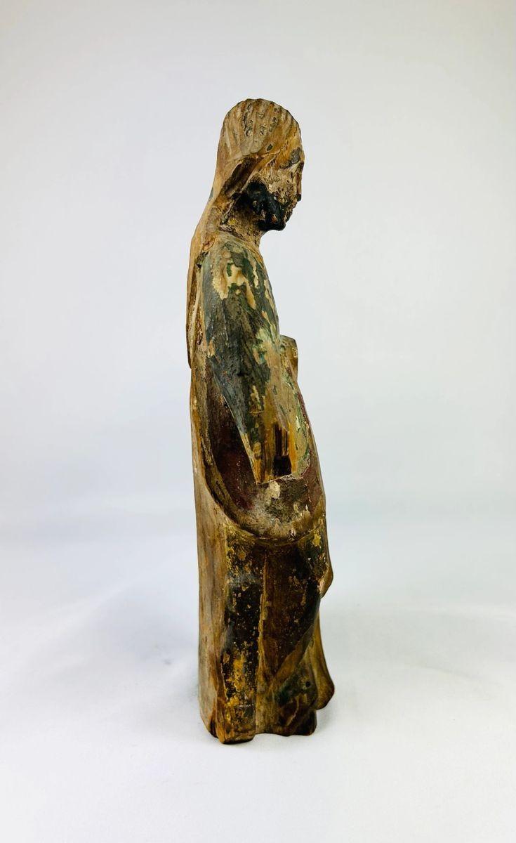 Historic Spanish Colonial devotional statue carved in wood, featuring serene facial expression and time-worn polychrome