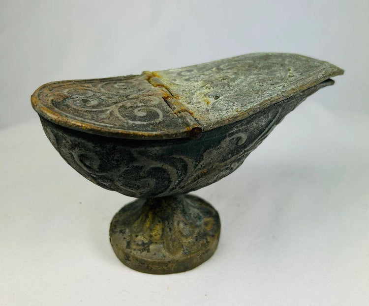 Han Dynasty bronze lamp with lid closed, highlighting engraved designs, curved body, and textured archaeological patina.