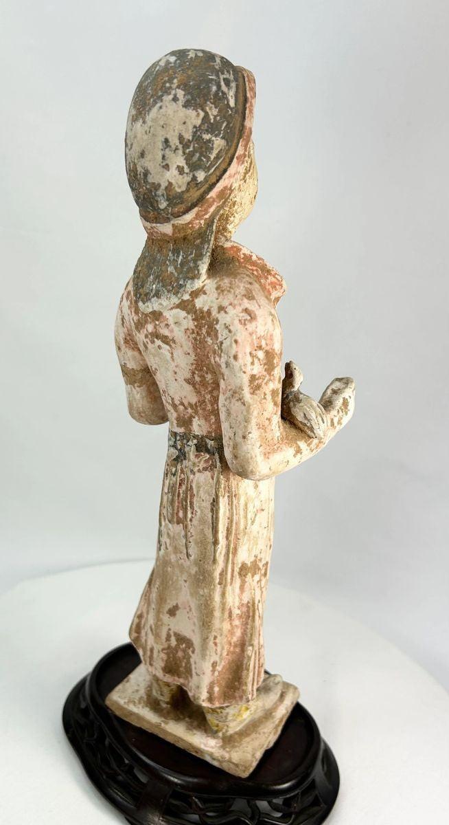 Low-fired terracotta Tang Dynasty tomb figure with serene expression and mineral burial patina