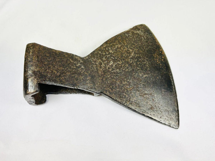 Antique European or Colonial American axe head showing trapezoidal cutting edge.