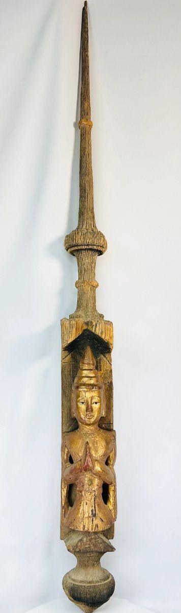Buddhist temple finial from Burma showing gilded Buddha figure beneath tapering spire
