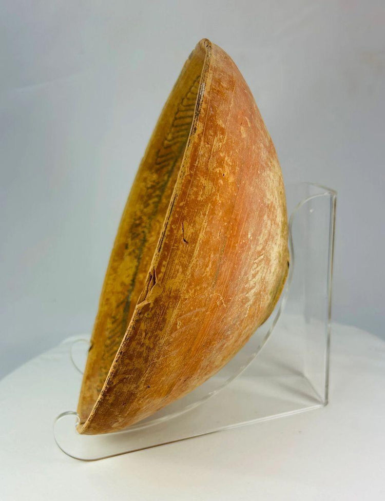 Ancient Indus Valley ceramic bowl with hand-painted geometric decoration on terracotta surface.