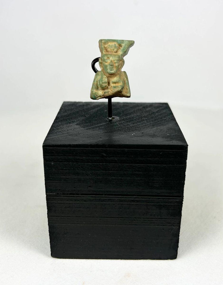 lion headed goddess sekhmet amulet on black wooden stand