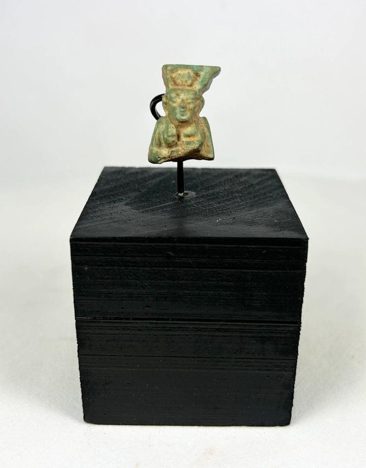 lion headed goddess sekhmet amulet on black wooden stand