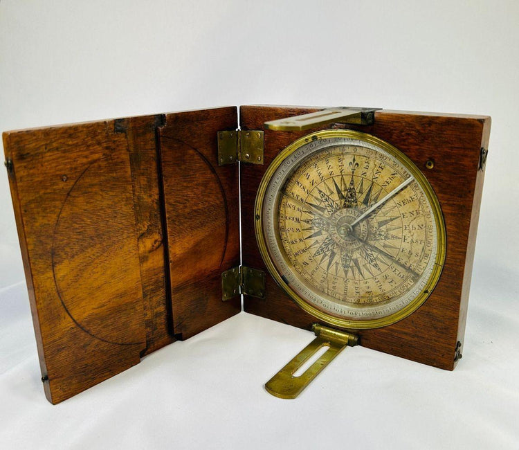 Vintage 19th century surveying compass with brass alidade arms and raised lid for navigation use