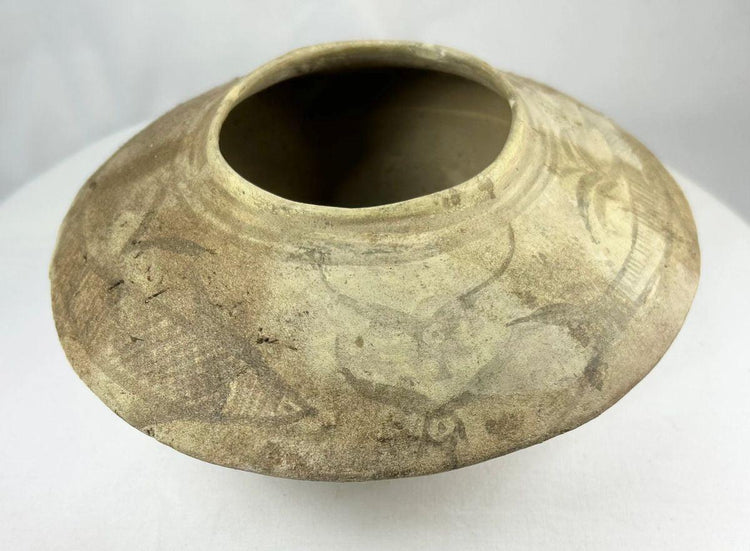 Ancient Harappan terracotta bowl showing stylized fish imagery and slip-painted decoration.