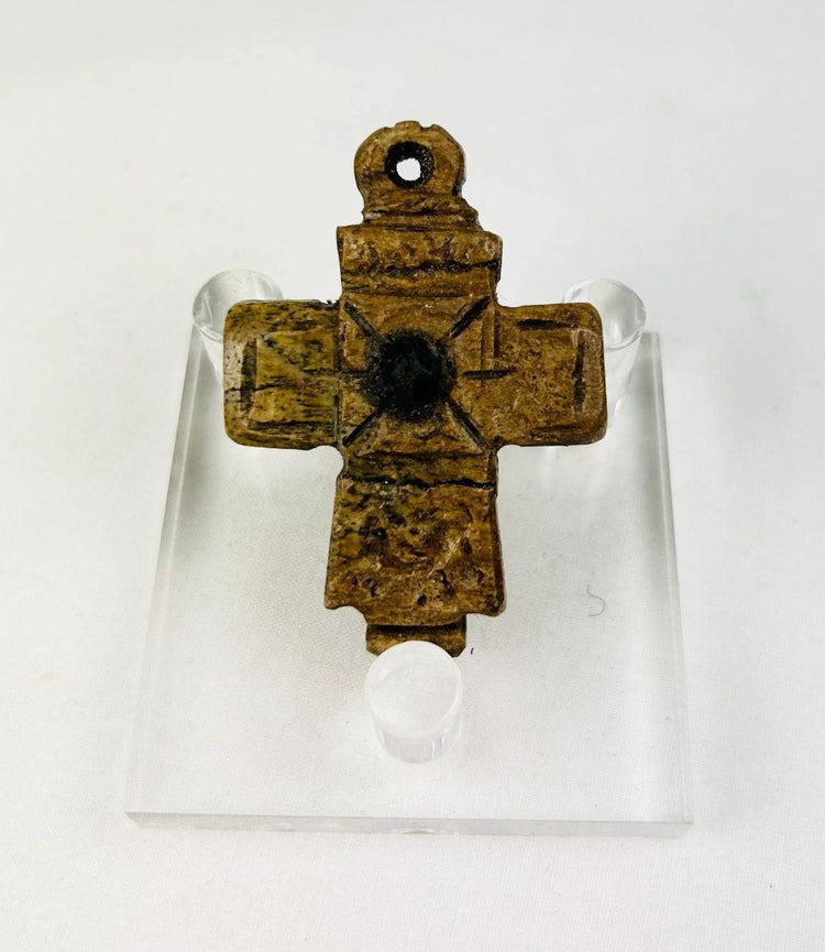 Hand-carved Byzantine bone cross showing worn patina from centuries of devotional use