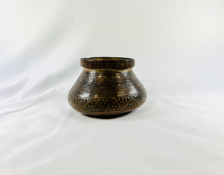 Pre-Columbian Mesoamerican pottery vessel showing painted polychrome patterns and rounded body shape.