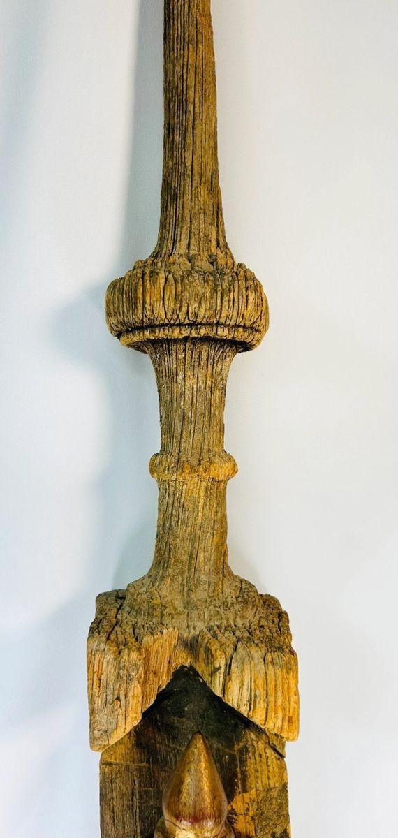 Southeast Asian Buddhist temple finial with devotional Buddha carving and weathered gilding