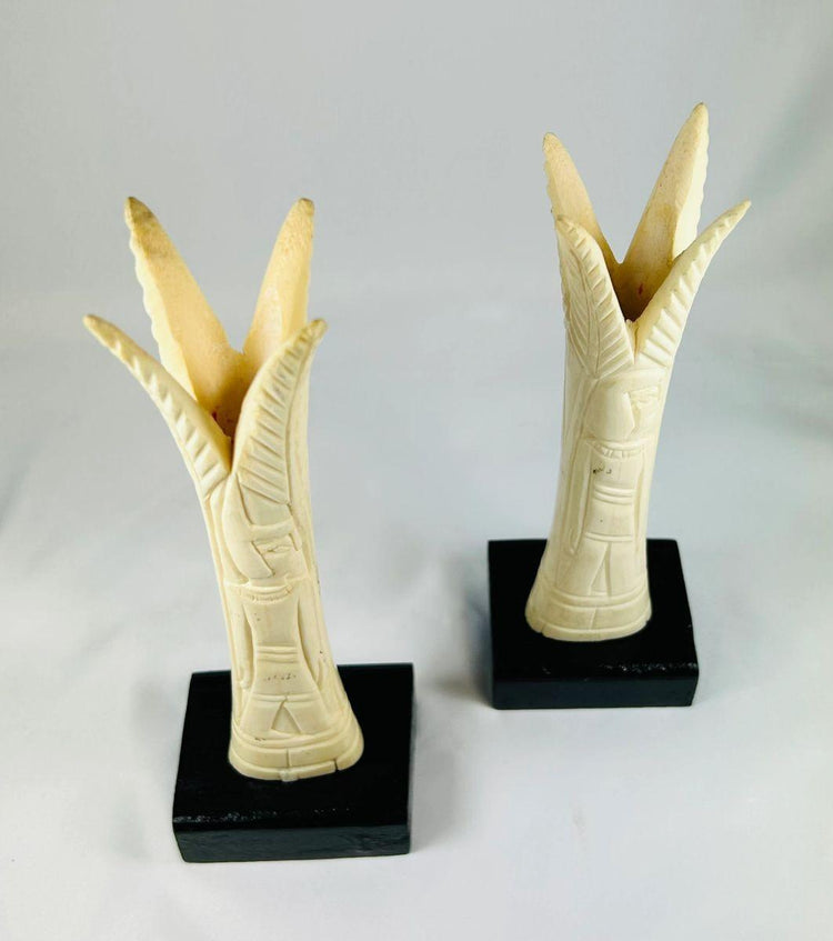 Egyptian ivory sistrum handles on black display bases, Third Intermediate Period, circa 1070–664 BCE, decorative motifs