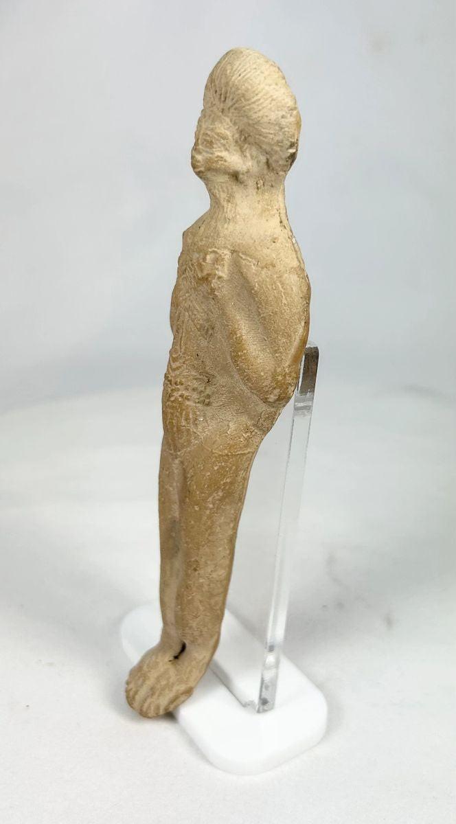 Full artifact image of ancient Roman terracotta fertility figurine on display stand.