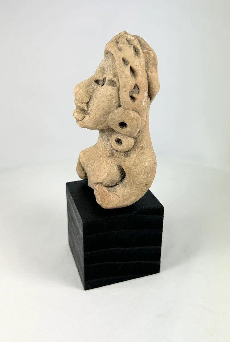 Pre-Columbian terracotta female figure from Nayarit or Jalisco, seated with arms resting on knees