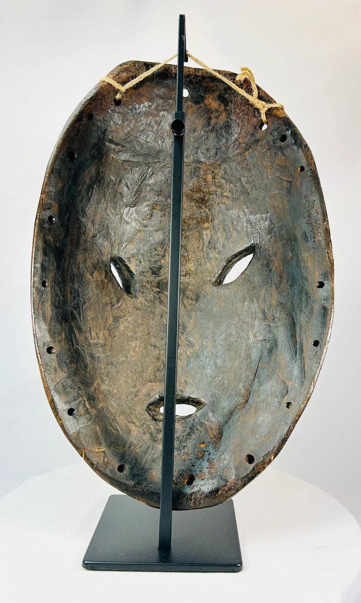 Back view of a Sepik River wooden mask with attachment holes for adornments