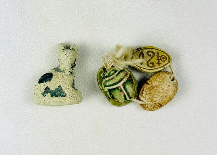 Ancient Egyptian faience cat amulet of Bastet with three scarab amulets, Late Period to Ptolemaic, 600–200 BCE